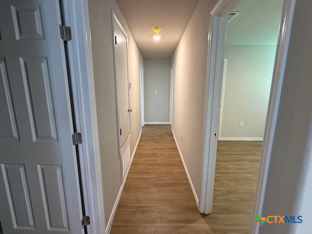 2410 Westcliff Road, Unit A Killeen, TX 76543 - Photo 11 of 22 a view of a hallway with wooden floor