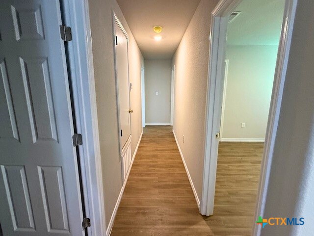 2410 Westcliff Road, Unit A Killeen, TX 76543 - Photo 17 of 22 a view of a hallway with wooden floor