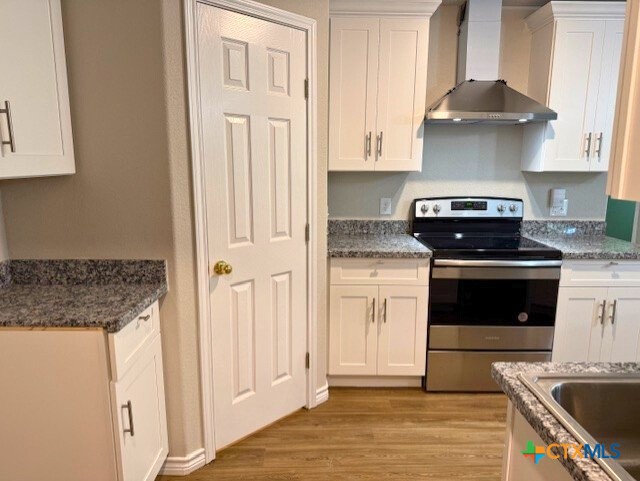 2410 Westcliff Road, Unit A Killeen, TX 76543 - Photo 7 of 22 a kitchen with granite countertop a stove and a sink
