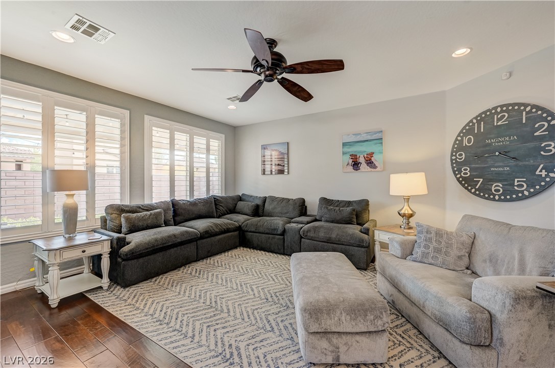 7049 Motley Road Las Vegas, NV 89178 - Photo 20 of 61 Rich hardwood floors and classic plantation shutters anchor this inviting living space.