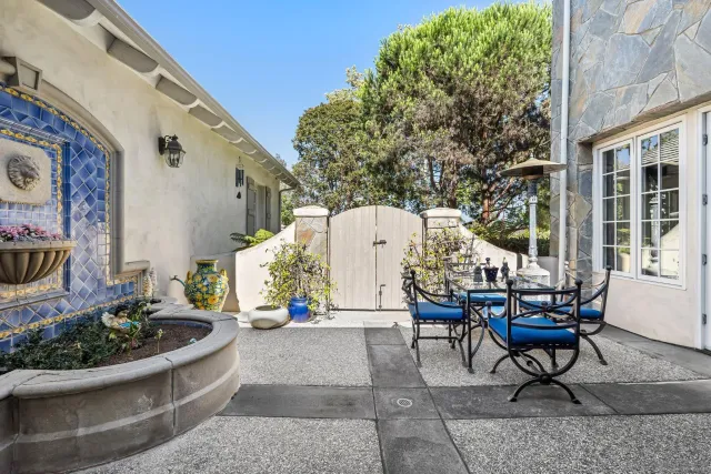 a building outdoor space with patio furniture and potted plants
