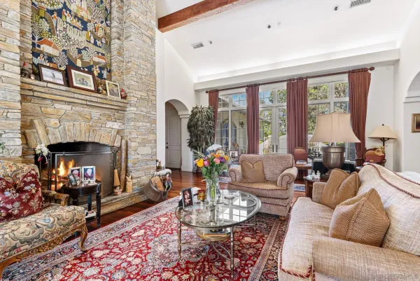 a living room with furniture fireplace and a large window