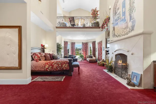 a living room with furniture a fireplace and a chandelier