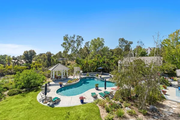 a swimming pool with some trees in the background