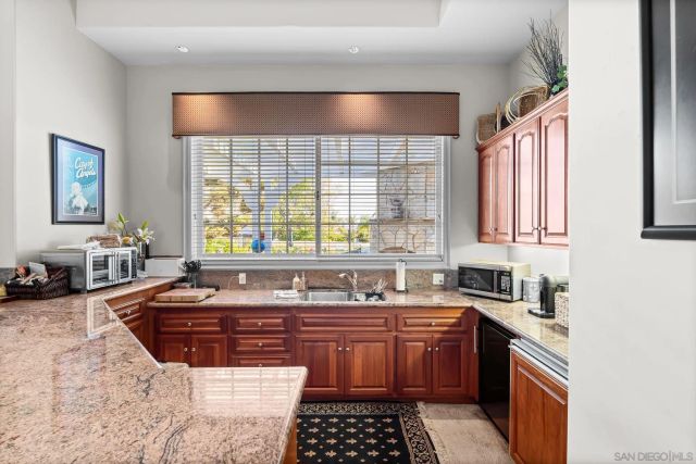 a kitchen with a sink a stove and cabinets