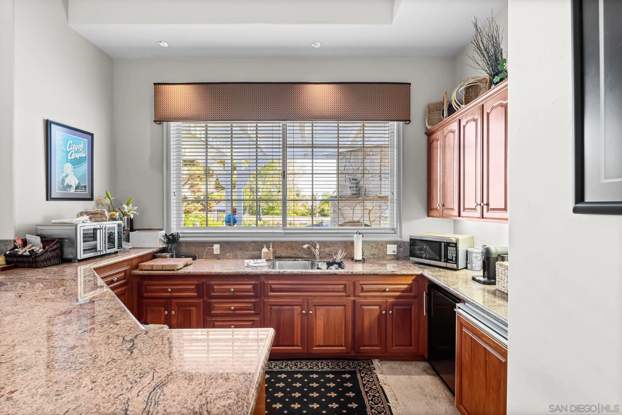 14786 Rancho Santa Fe Farms Road Rancho Santa Fe, CA 92067 - Photo 38 of 49 a kitchen with a sink a stove and cabinets