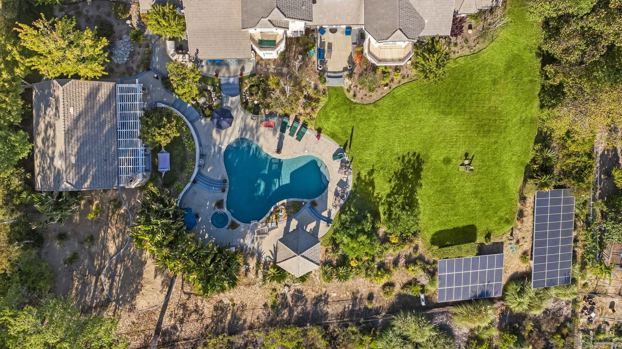 14786 Rancho Santa Fe Farms Road Rancho Santa Fe, CA 92067 - Photo 4 of 49 an aerial view of a residential apartment building with swimming pool and lawn chairs