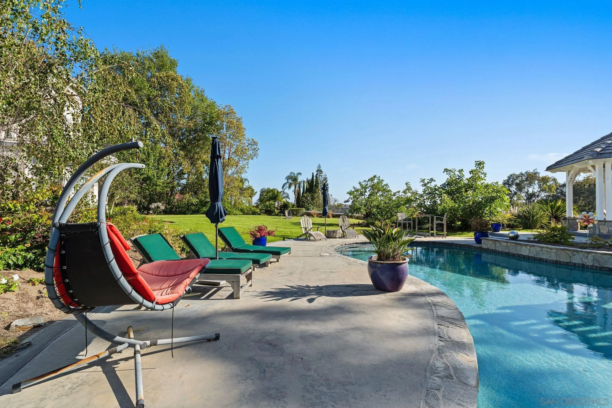 14786 Rancho Santa Fe Farms Road Rancho Santa Fe, CA 92067 - Photo 43 of 49 a view of a lake with a sitting area