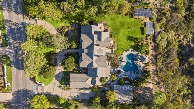 an aerial view of a house with outdoor space