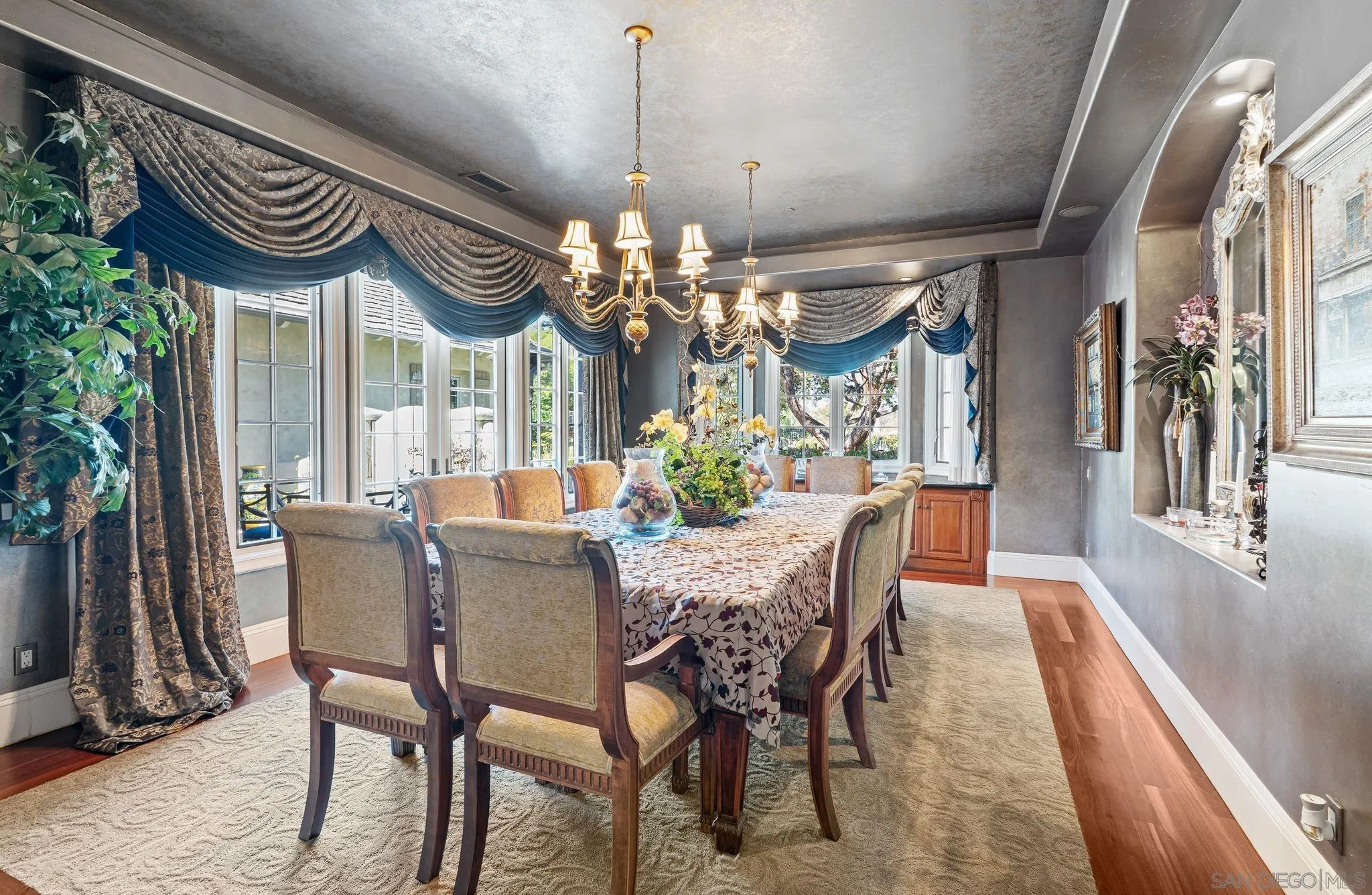 14786 Rancho Santa Fe Farms Road Rancho Santa Fe, CA 92067 - Photo 10 of 49 a dining room with furniture a chandelier and wooden floor