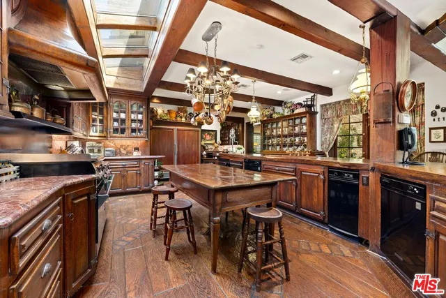 a open kitchen with a sink a counter space stainless steel appliances and cabinets