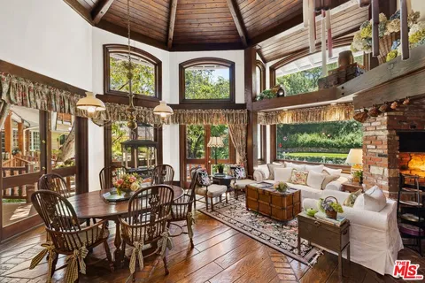 a view of a dining room with furniture window and outside view