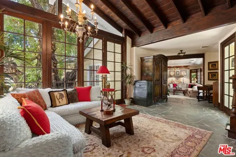 a living room with furniture a table and chairs
