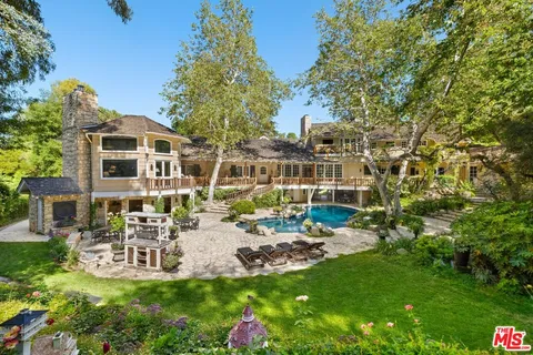 a view of a house with backyard porch and sitting area