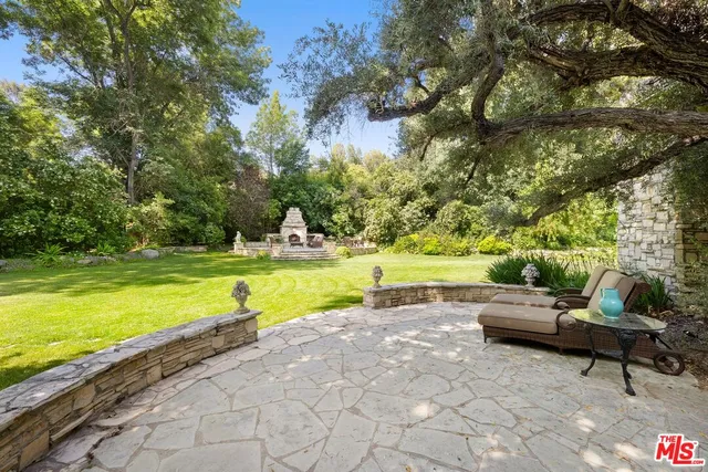 a view of a swimming pool and lounge chairs
