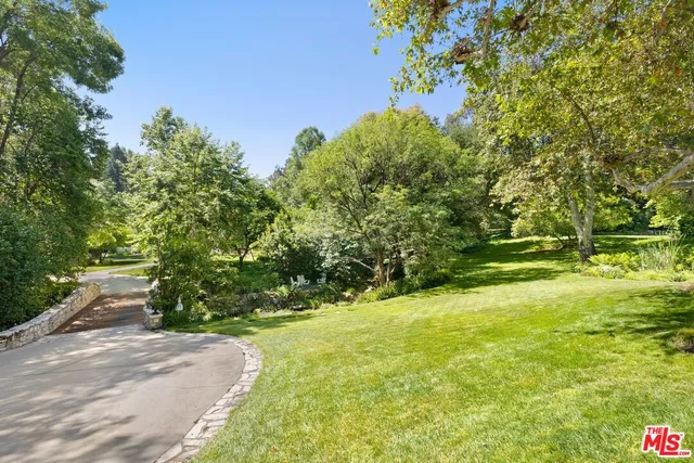 a view of yard with swimming pool and green space