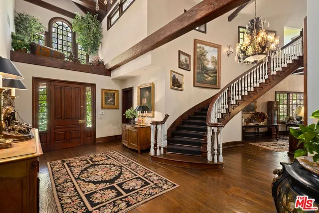 a living room with wooden floor and a rug