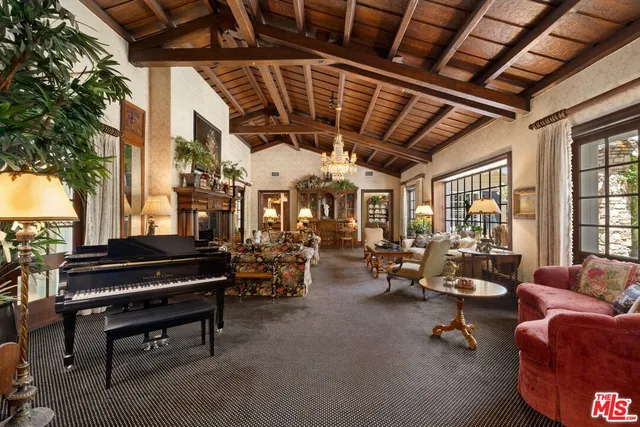 a living room with furniture a fireplace and a large window