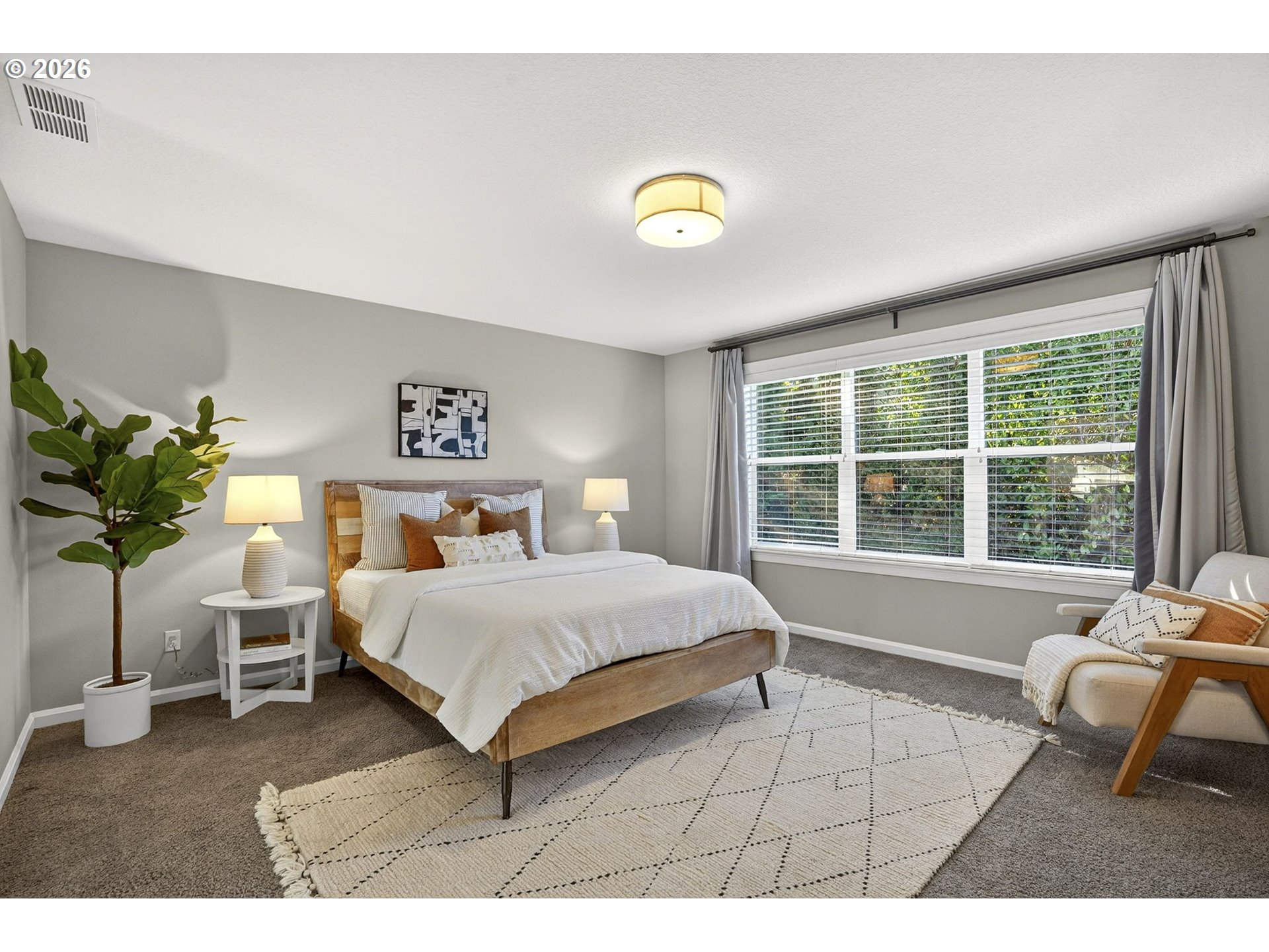 6123 Northeast 34th Avenue Portland, OR 97211 - Photo 24 of 42 a bedroom with a bed and a chair