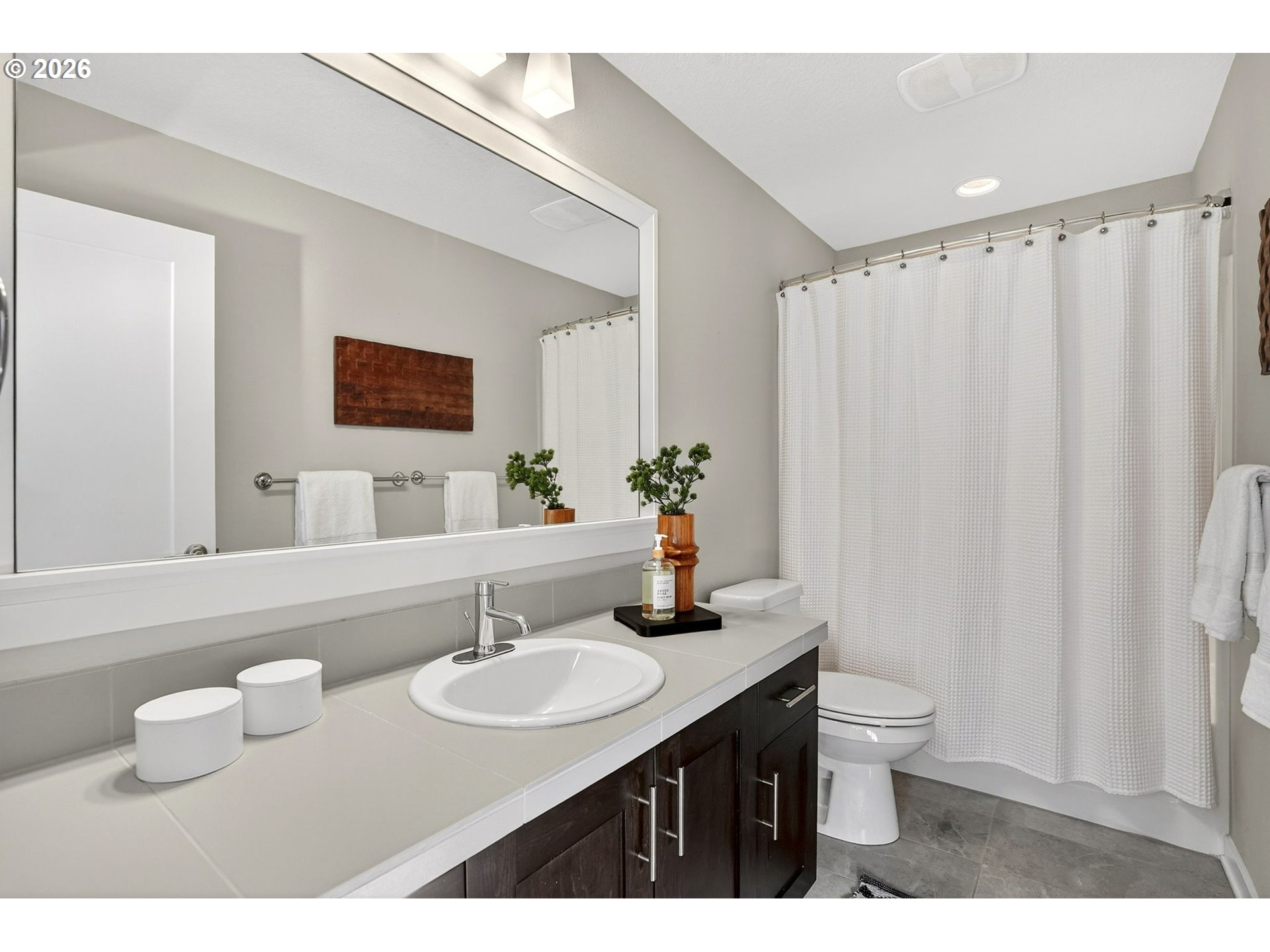 6123 Northeast 34th Avenue Portland, OR 97211 - Photo 35 of 42 a bathroom with a granite countertop sink and a mirror with toilet