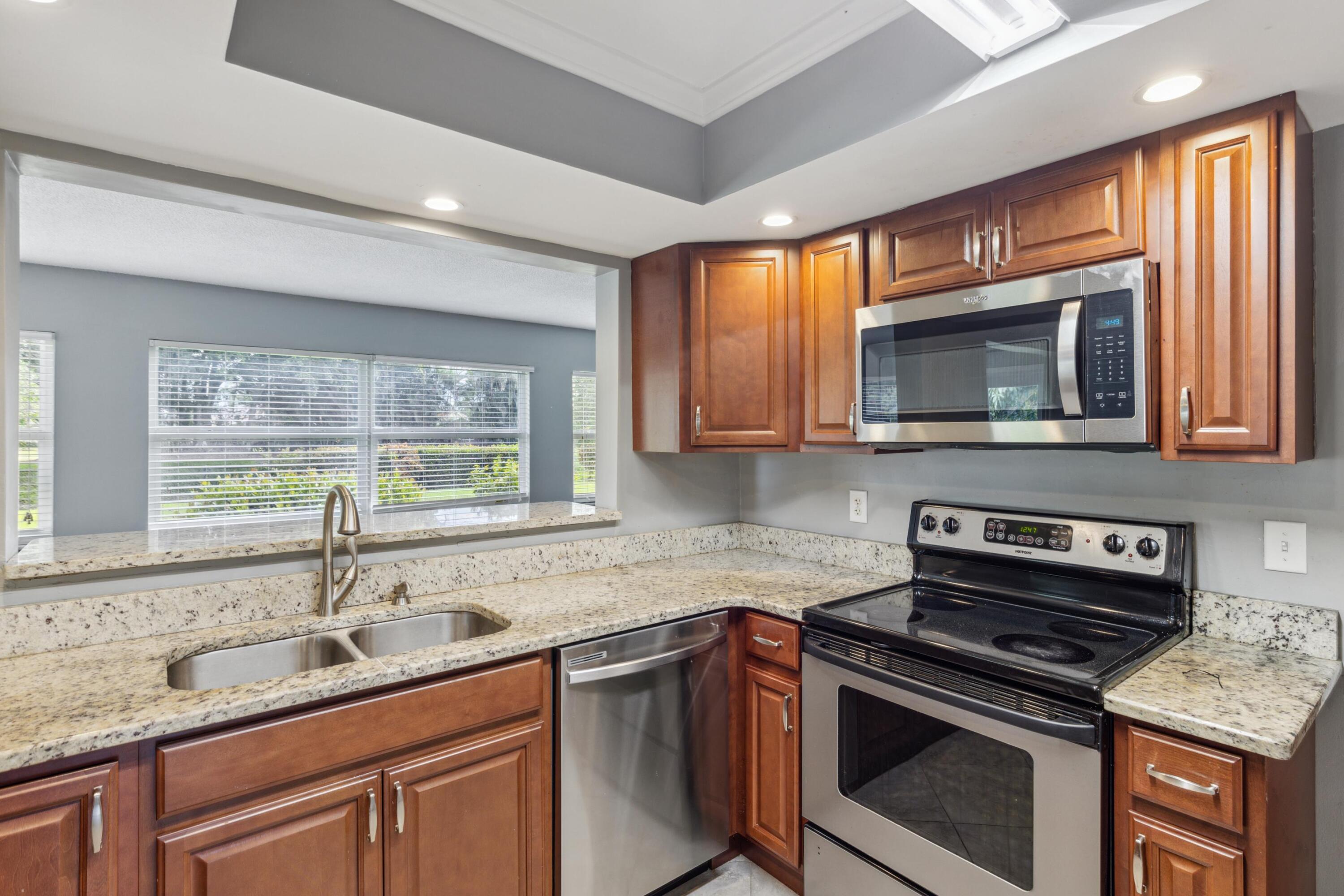 1536 Southeast Sunshine Avenue Port St. Lucie, FL 34952 - Photo 3 of 18 a kitchen with a sink stove top oven and microwave