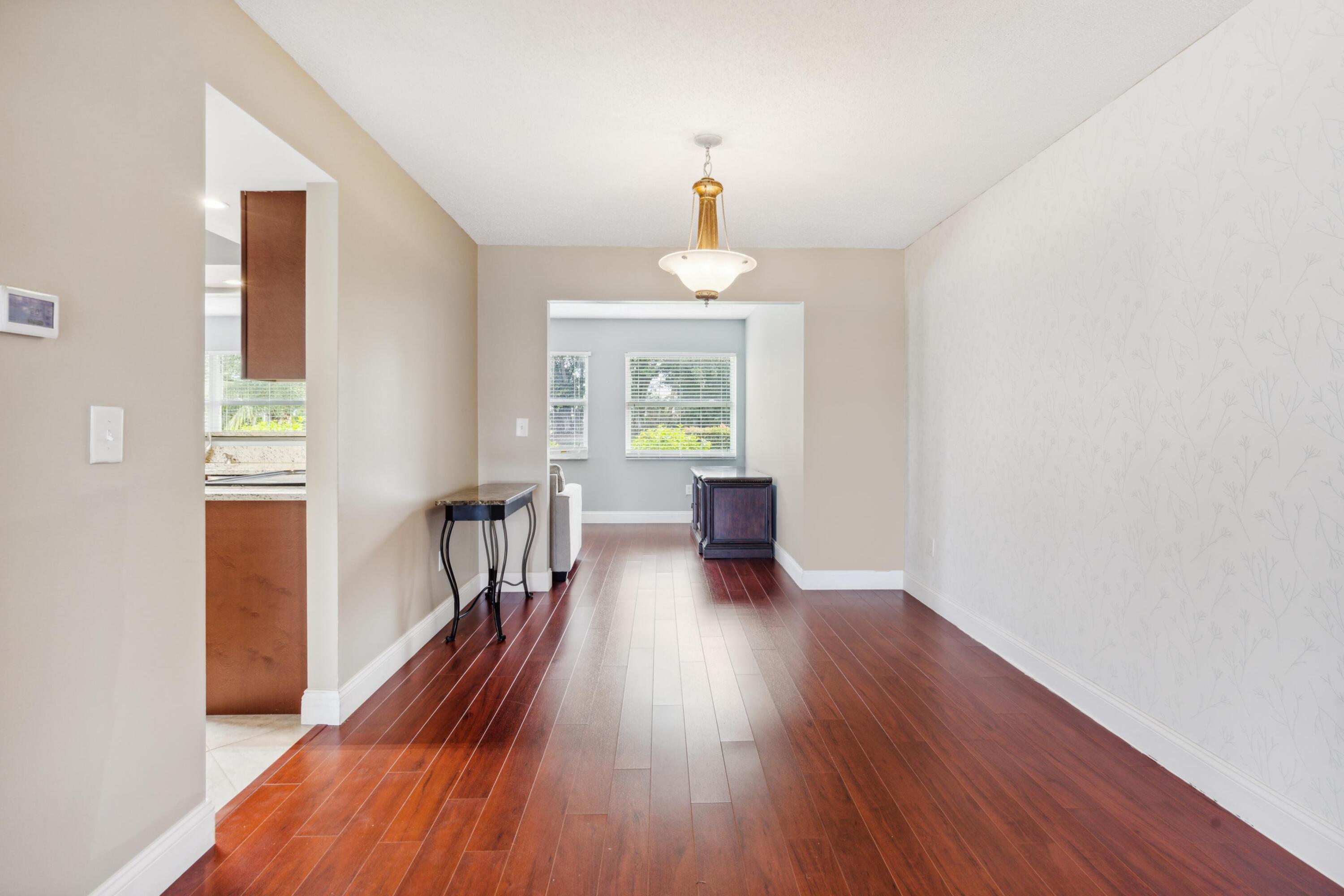 1536 Southeast Sunshine Avenue Port St. Lucie, FL 34952 - Photo 8 of 18 a view of a room with wooden floor staircase and a livingroom