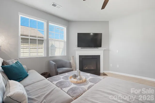 a living room with furniture a flat screen tv and a fireplace