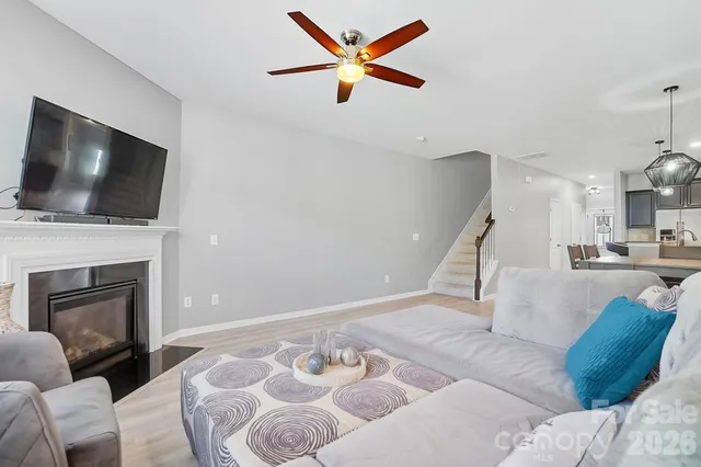 a living room with furniture and view of kitchen