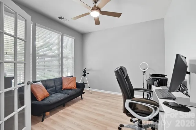 a view of workspace with wooden floor and lounge chair