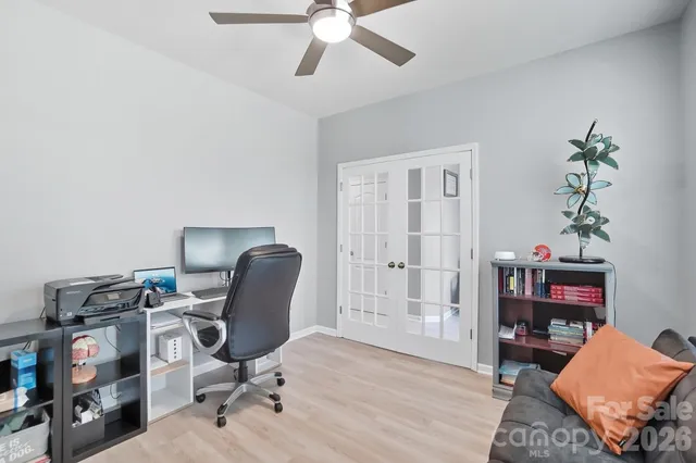 a work room with furniture and a flat screen tv