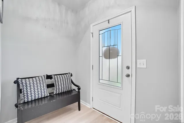 a kitchen with stainless steel appliances kitchen island granite countertop a stove a refrigerator a sink a dining table and chairs with wooden floor