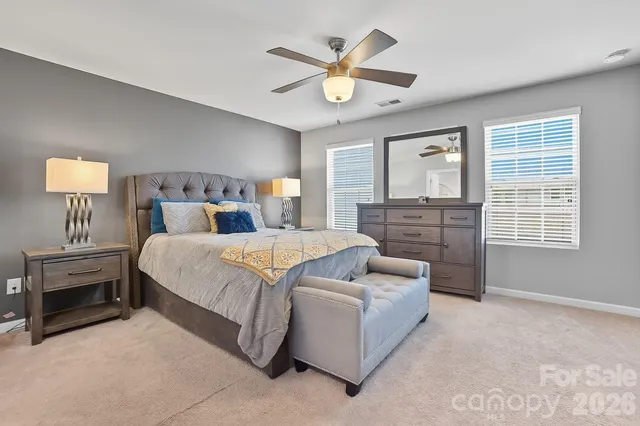 a bedroom with a bed and a lamp