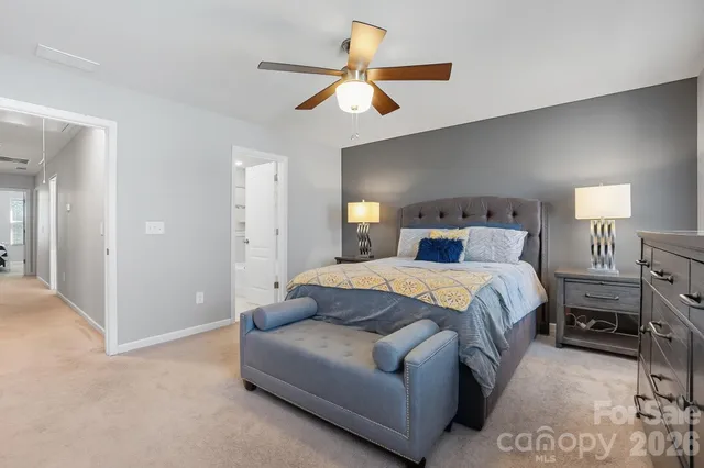 a bedroom with a bed a window and a flat screen tv