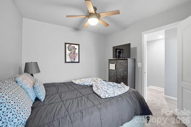 a bedroom with a bed and a lamp