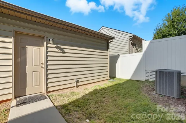 a view of a house with a wooden fence