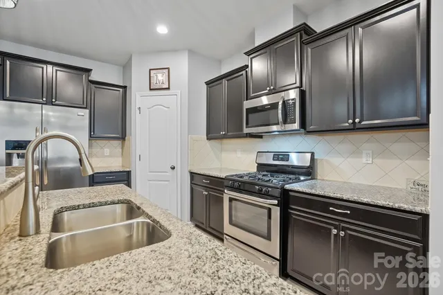 a kitchen with a sink stove and refrigerator