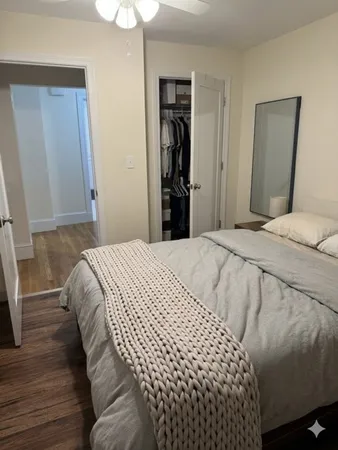 a bedroom with a bed and a mirror