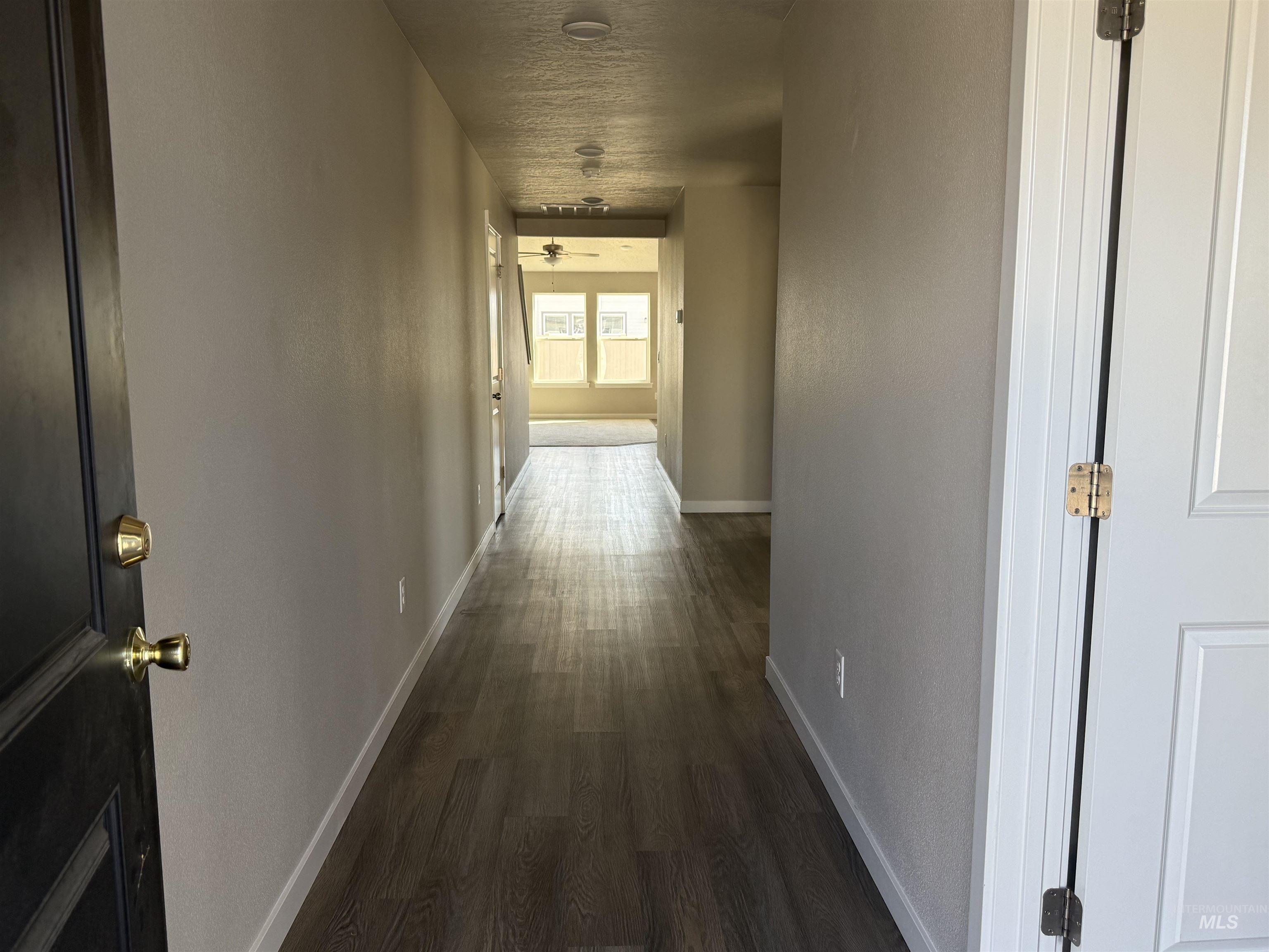12451 Varga Street Caldwell, ID 83607 - Photo 5 of 30 Hallway featuring wood-finish flooring, recessed lighting, and a neutral wall palette