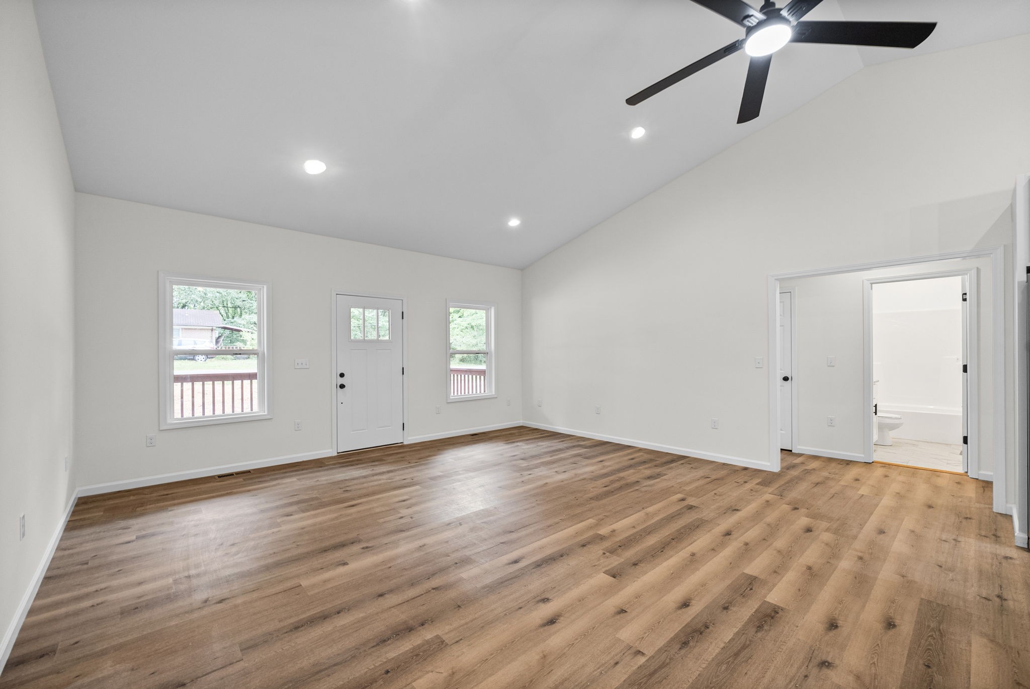690 Brazzle Road Waverly, TN 37185 - Photo 7 of 35 a view of an empty room with a window and wooden floor