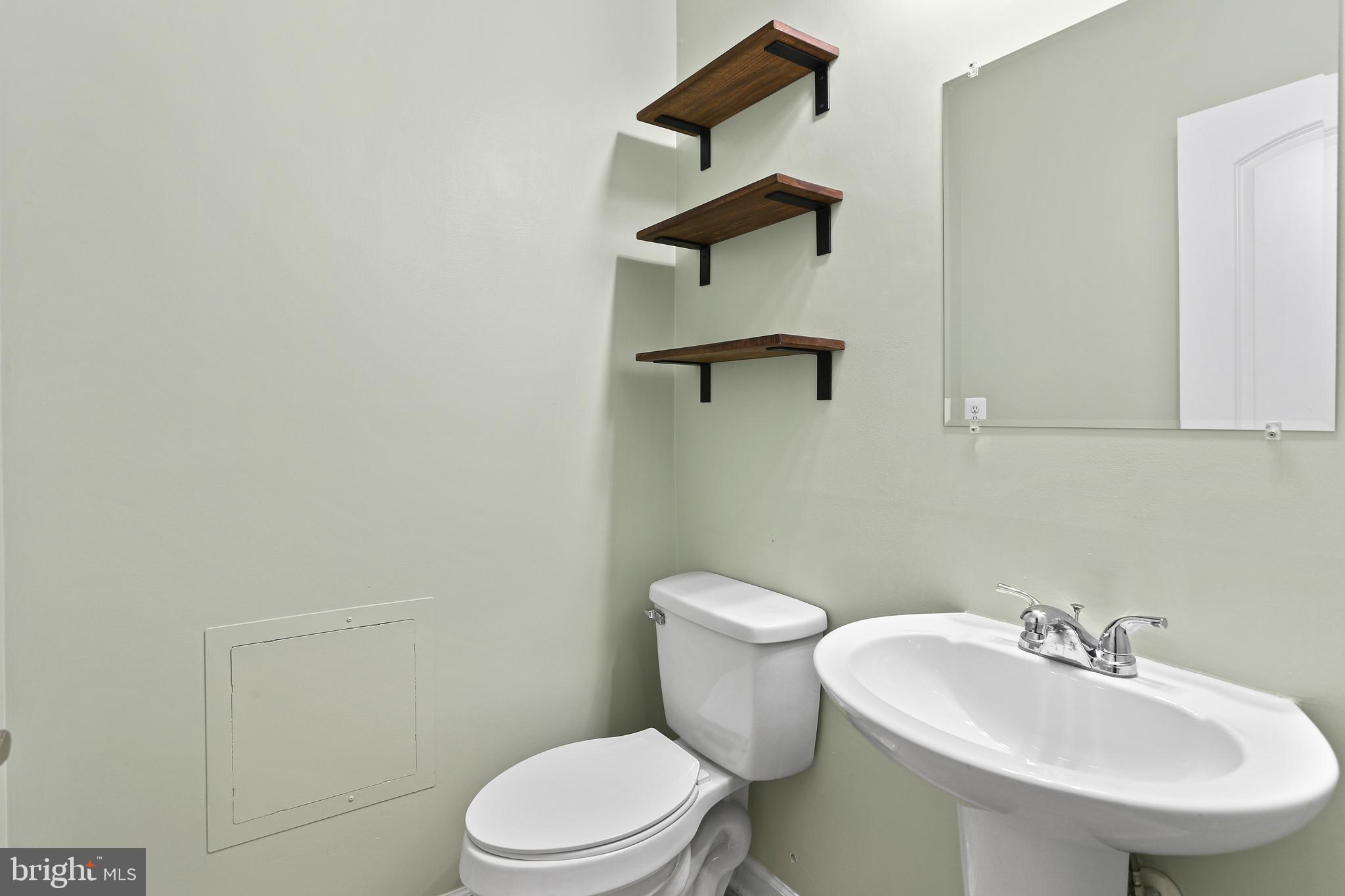 2719 Amber Crest Road Hanover, MD 21076 - Photo 12 of 22 a white toilet sitting next to a bathroom sink