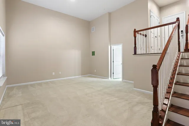 a view of an empty room with stairs