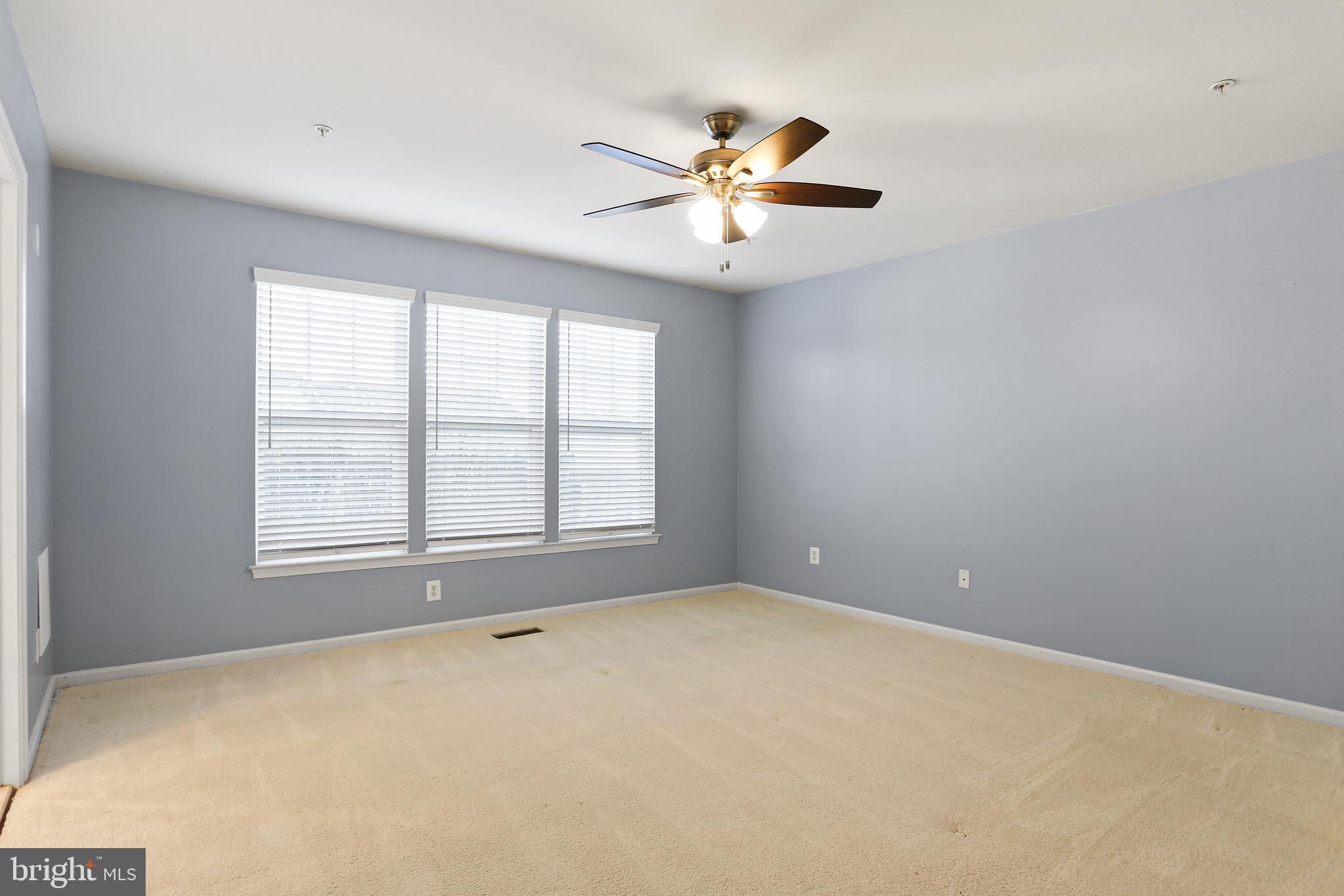 2719 Amber Crest Road Hanover, MD 21076 - Photo 7 of 22 a view of an empty room with chandelier fan and a window