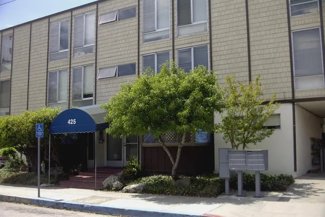 a front view of a building with garden