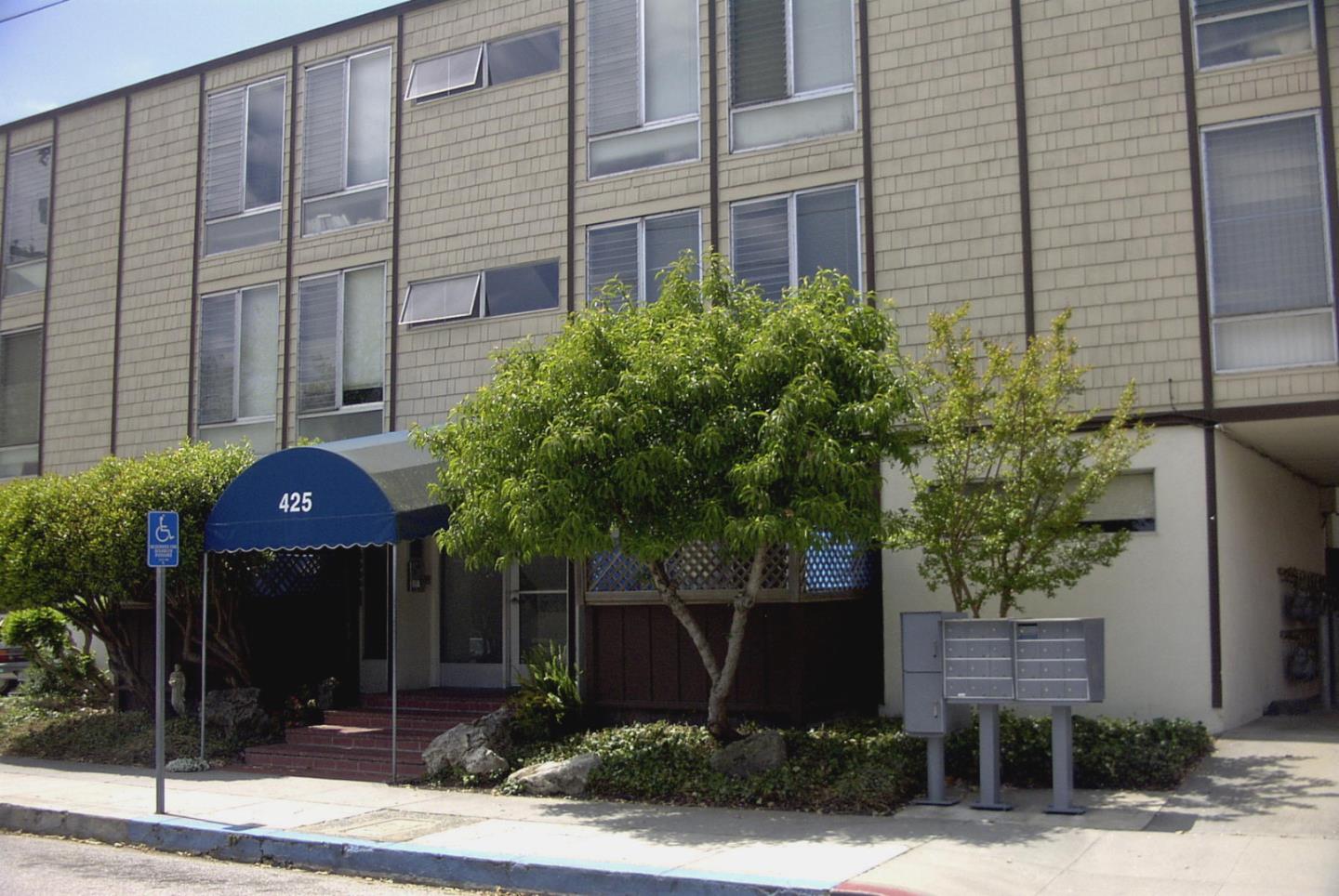 a front view of a building with garden