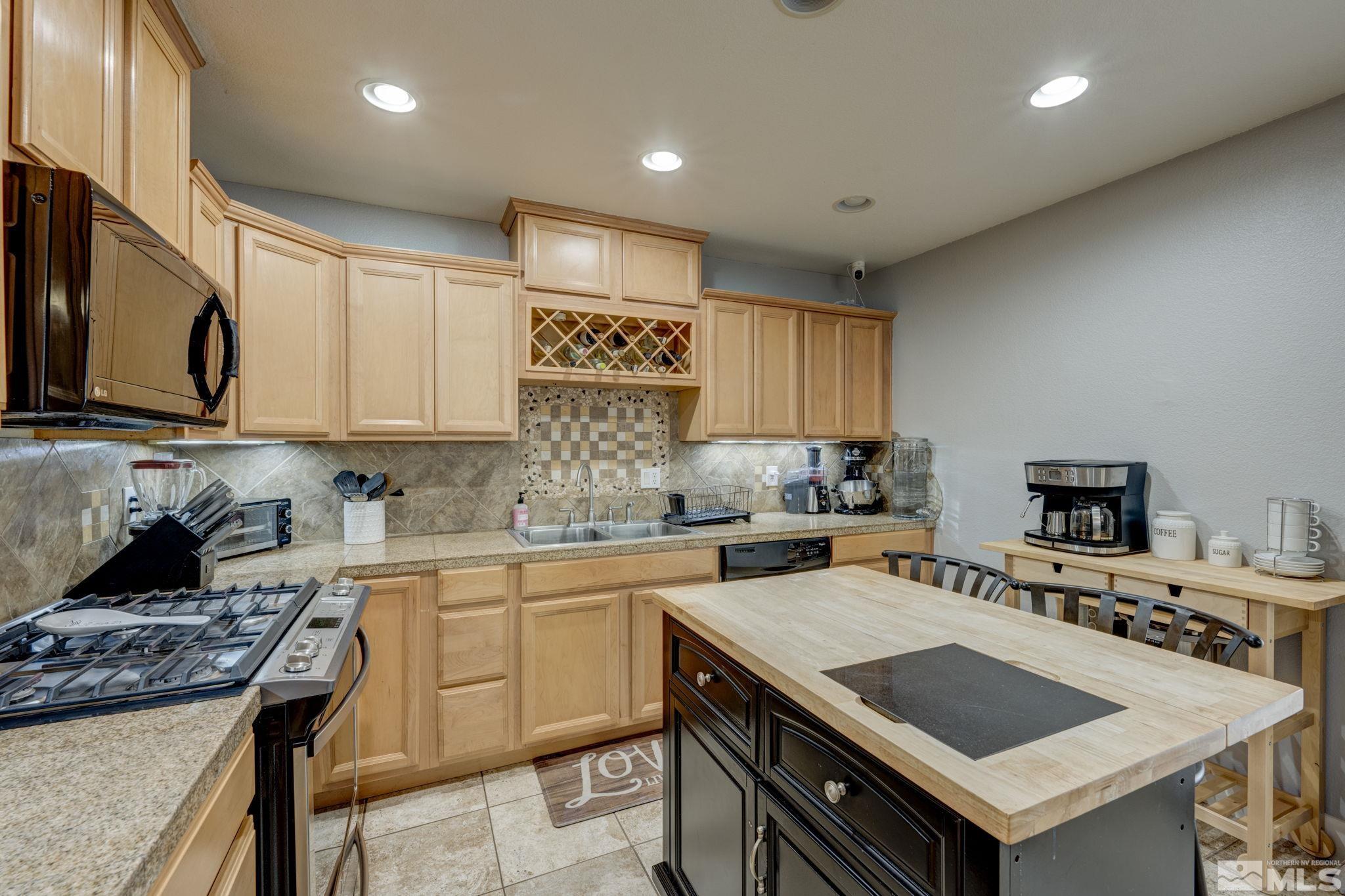 3450 West 7th Street Reno, NV 89503 - Photo 14 of 40 a kitchen with a stove a sink a microwave and cabinets