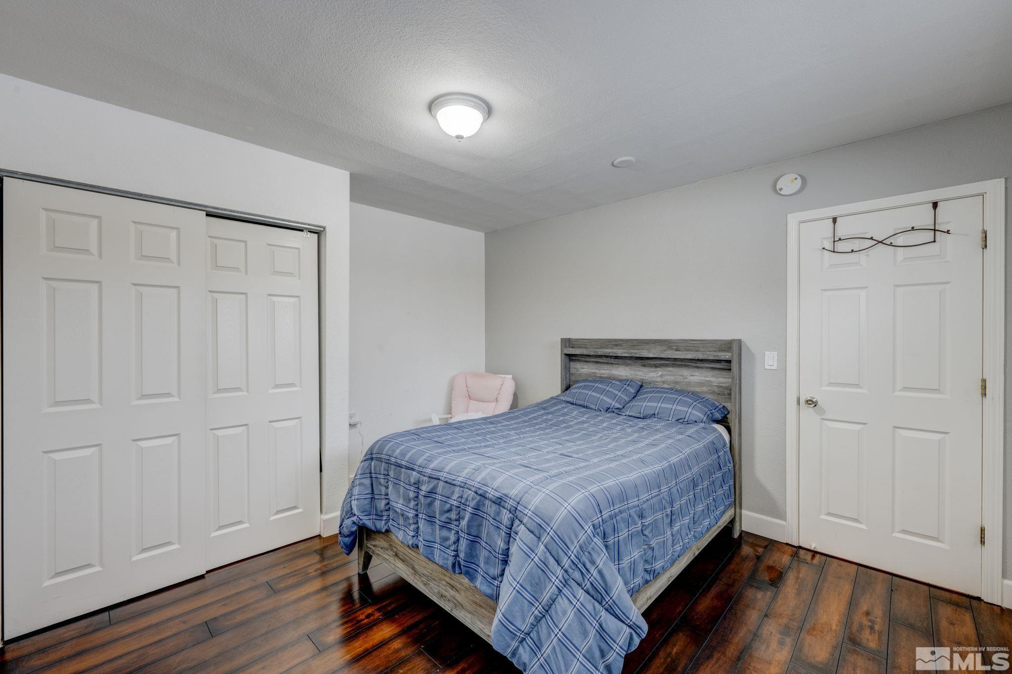 3450 West 7th Street Reno, NV 89503 - Photo 21 of 40 a bedroom with a bed and wooden floor