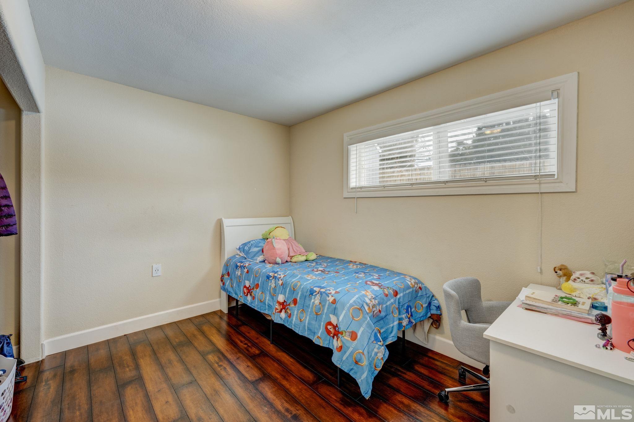 3450 West 7th Street Reno, NV 89503 - Photo 22 of 40 a bedroom with a bed and wooden floor