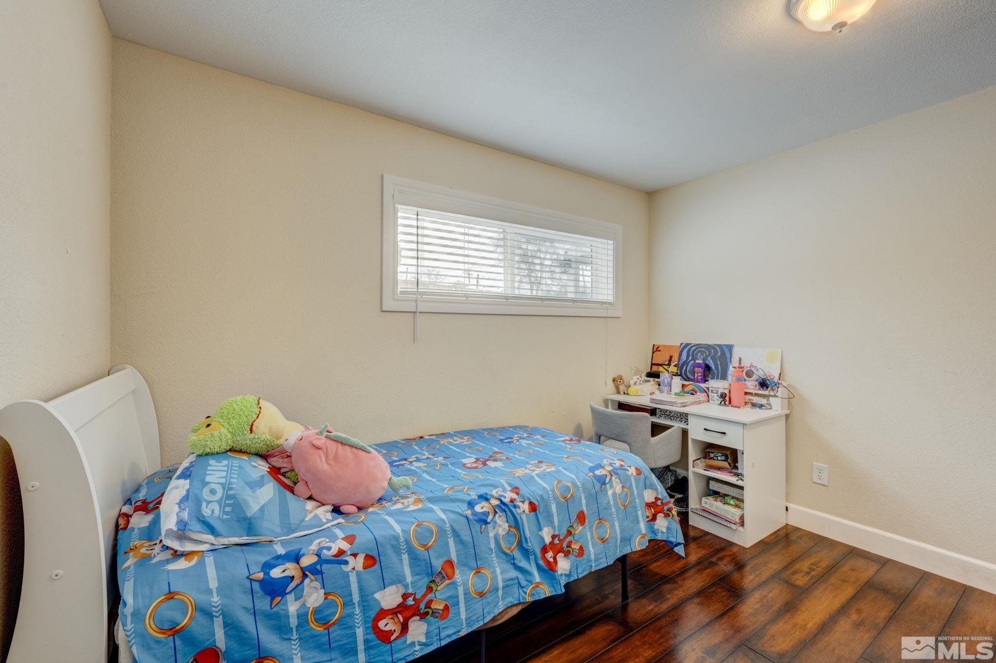 3450 West 7th Street Reno, NV 89503 - Photo 23 of 40 a bedroom with a bed and wooden floor