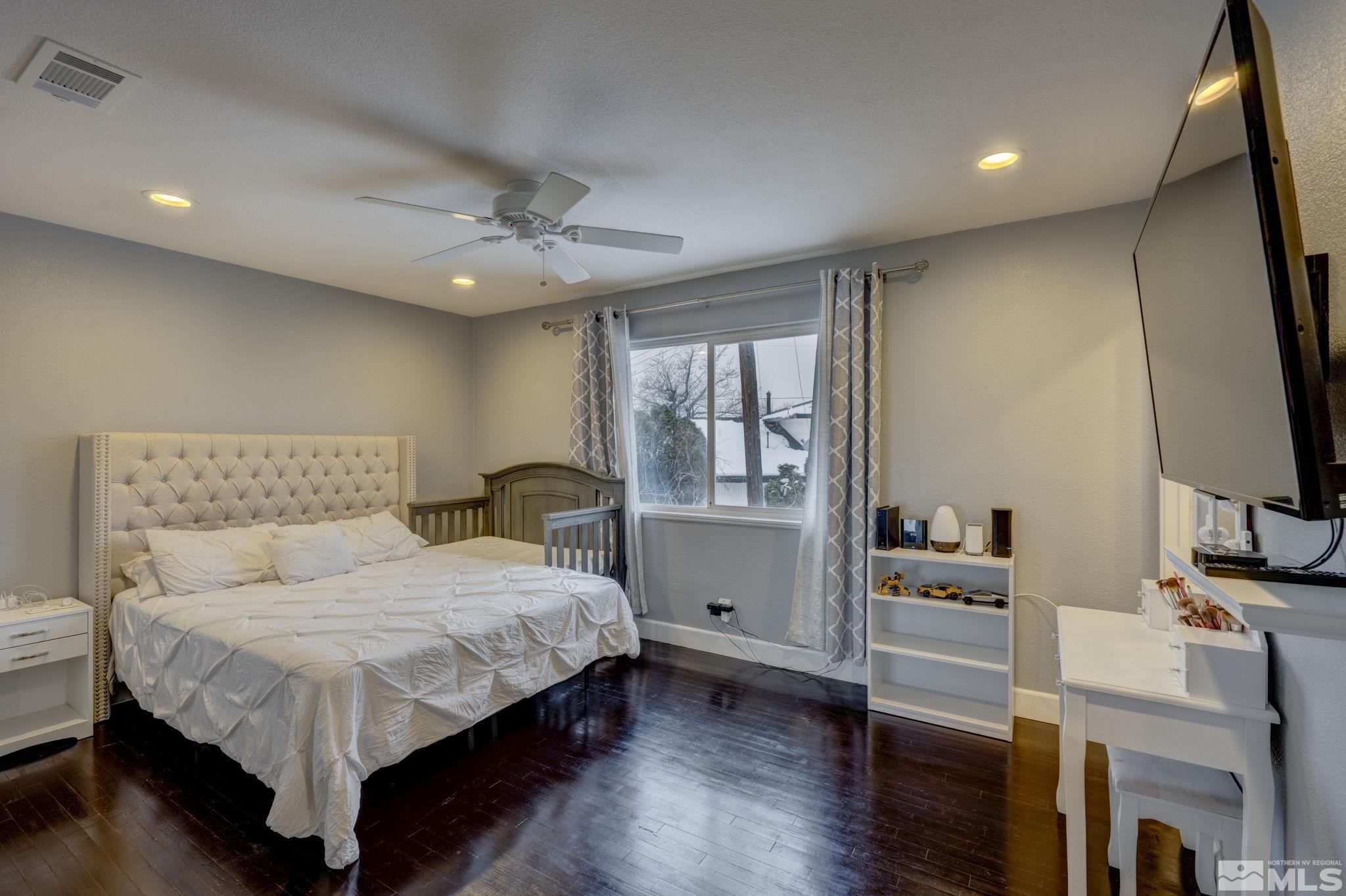 3450 West 7th Street Reno, NV 89503 - Photo 27 of 40 a bedroom with a bed and a flat screen tv