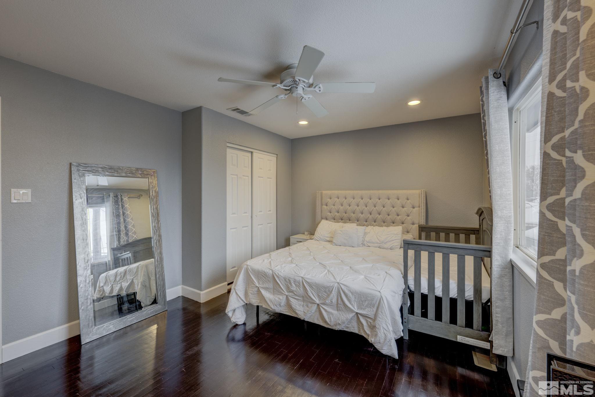 3450 West 7th Street Reno, NV 89503 - Photo 28 of 40 a bedroom with a bed and wooden floor